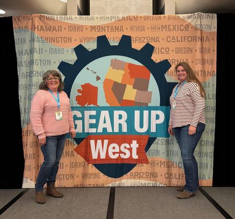 Two women standing next to a banner that says, "GEAR UP West"