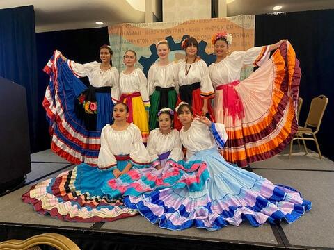 A group of folklorico dancers posing for a photo.