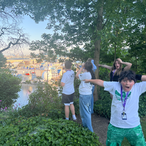 Students pointing to a lake