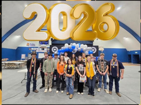Several students standing in front of balloons and a large "2026" above them